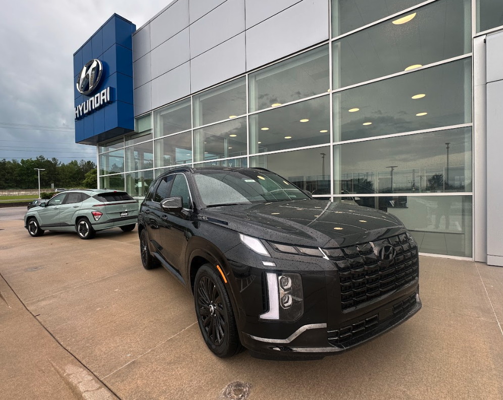 Black Hyundai SUV parked in front of Crain Hyundai of Fayetteville, showcasing advanced safety features